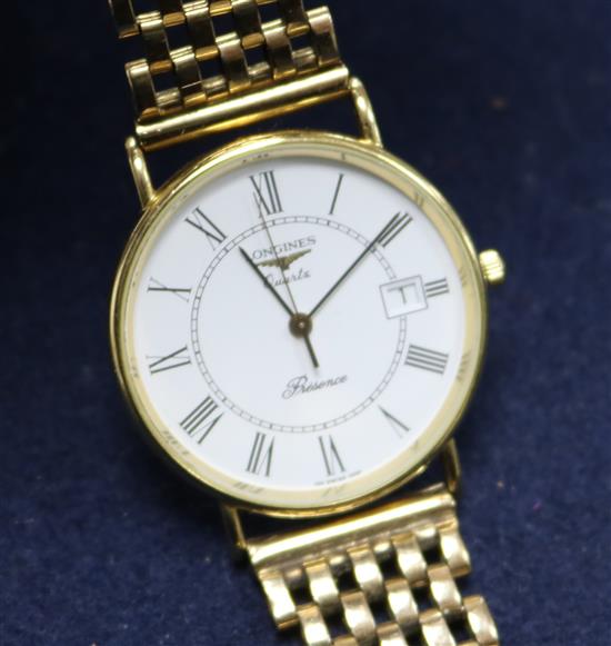 A gentlemans 9ct gold Longines quartz wrist watch on an associated 9ct gold bracelet.